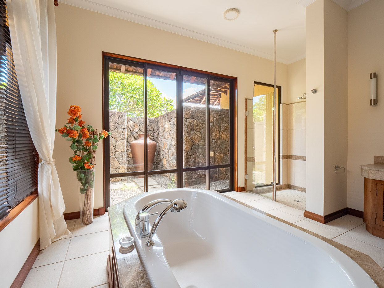 Master bedroom suite with tropical decor in Ohana Heritage Group’s Tamarina property