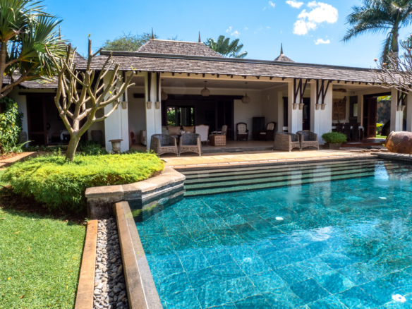 Exclusive villa exterior showcasing expansive terrace and landscaped garden in Mauritius